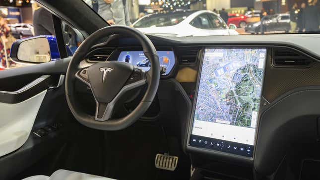 A photo of the dashboard in a Tesla. 