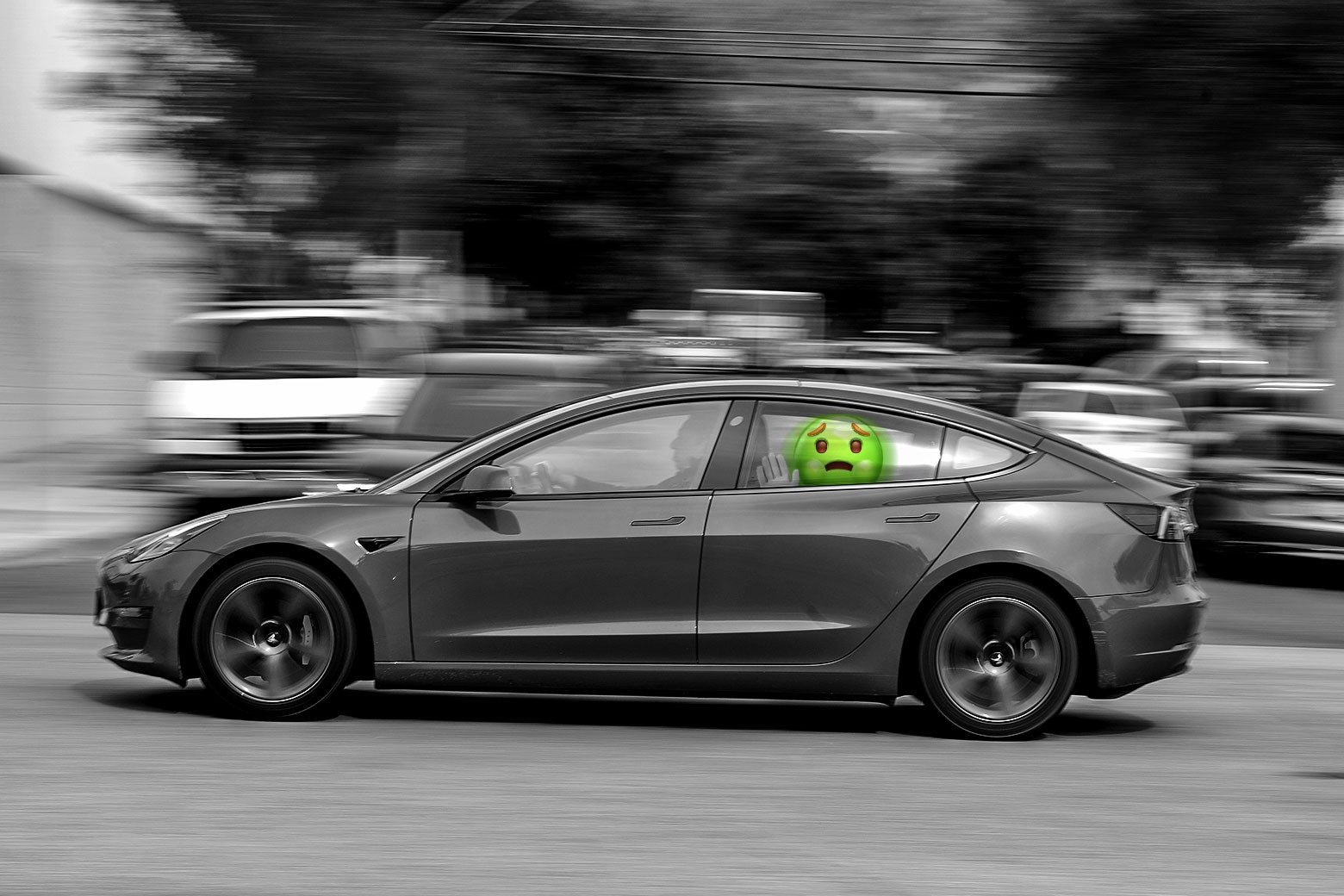 Black-and-white image of a Tesla car, with a queasy-looking emoji face passenger in the back seat.