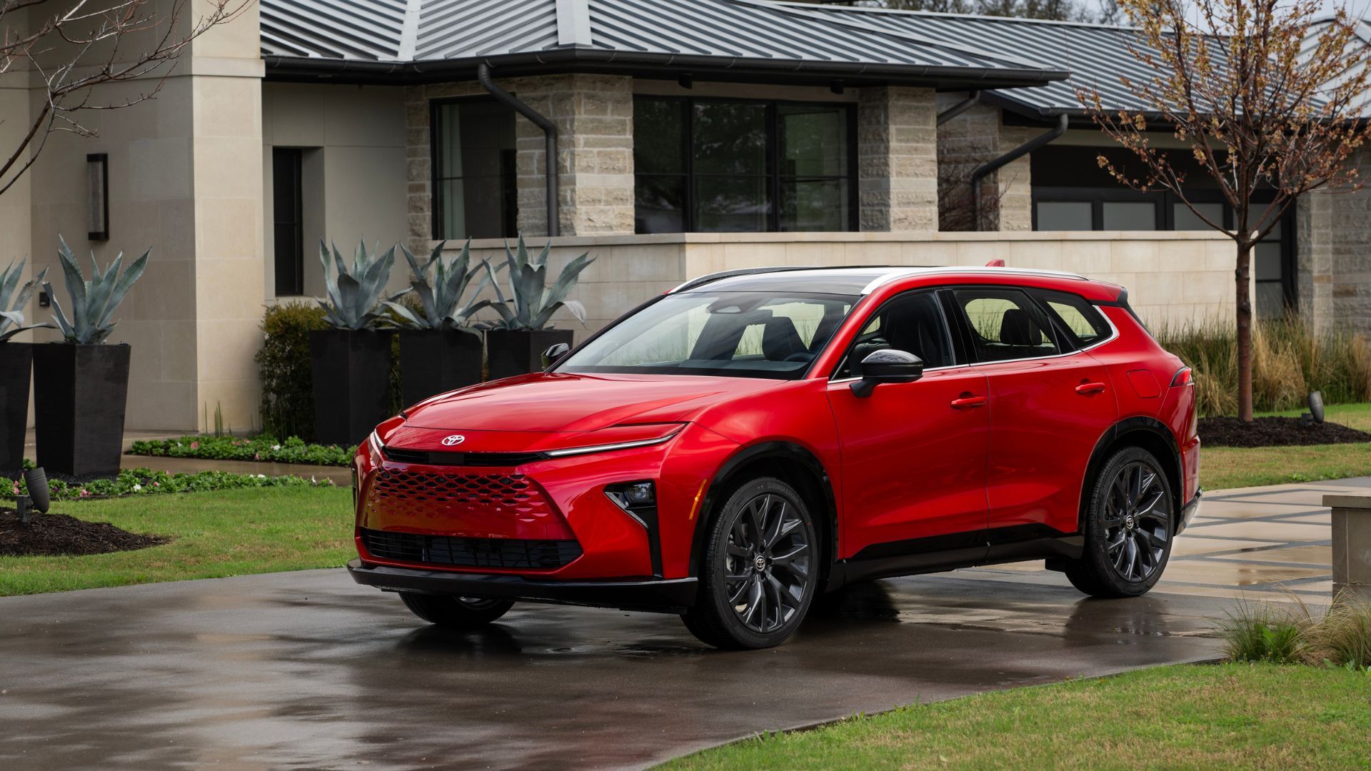 Static front 3/4 shot of a red 2025 Toyota Crown Signia Limited.