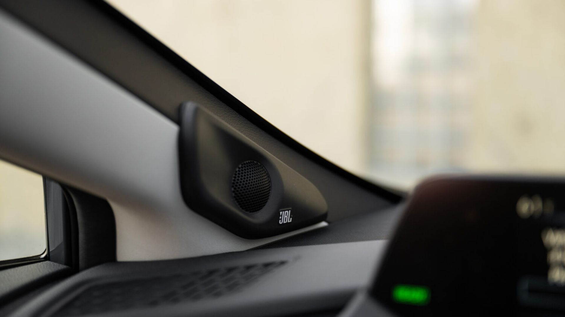 Cloose-up shot of the JBL speaker system in a 2025 Toyota Prius PHEV XSE Premium.