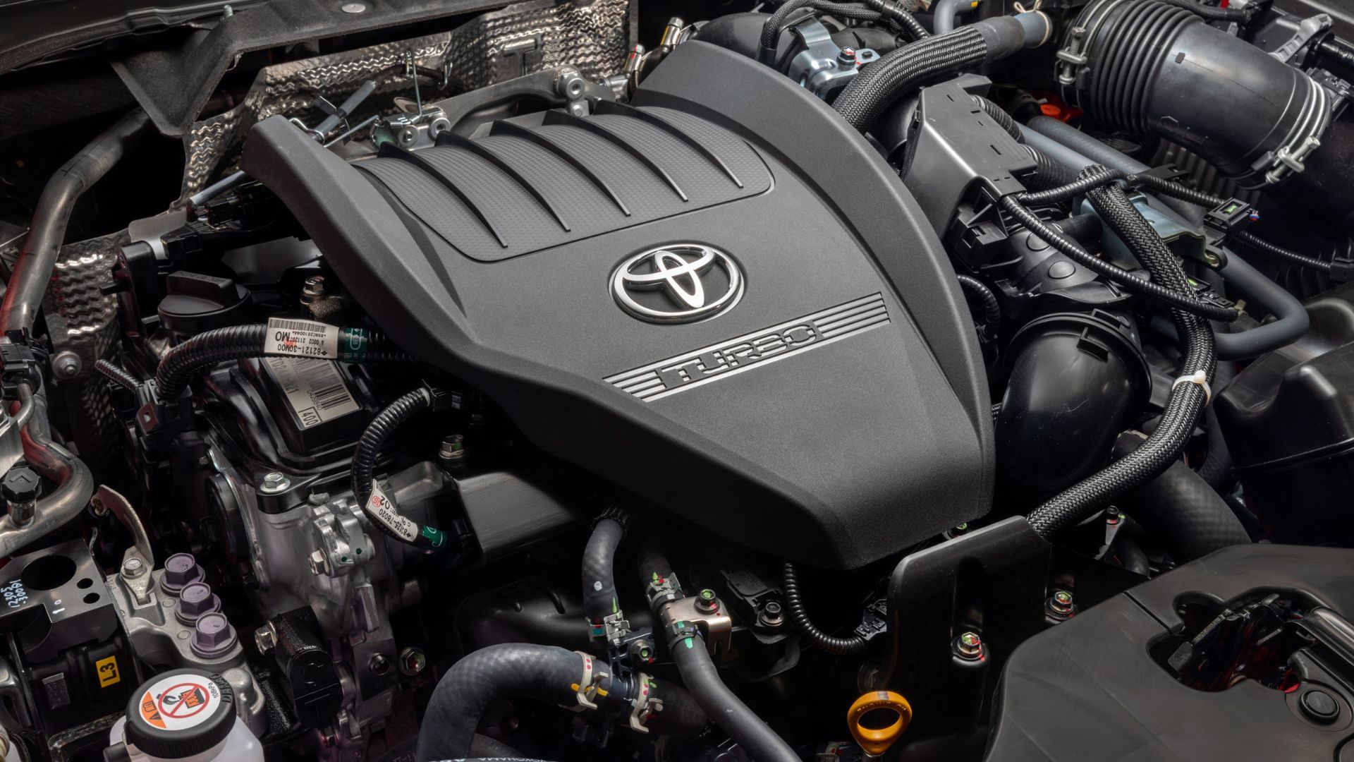 Close-up shot of the 2.4-liter engine under the hood of a 2026 Toyota Crown Platinum.