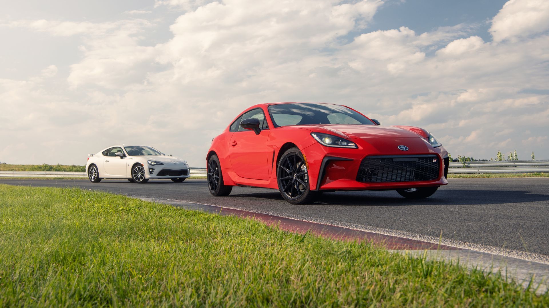 Dynamic shot of a red and white 2022 Toyota GR86s on a racetrack.