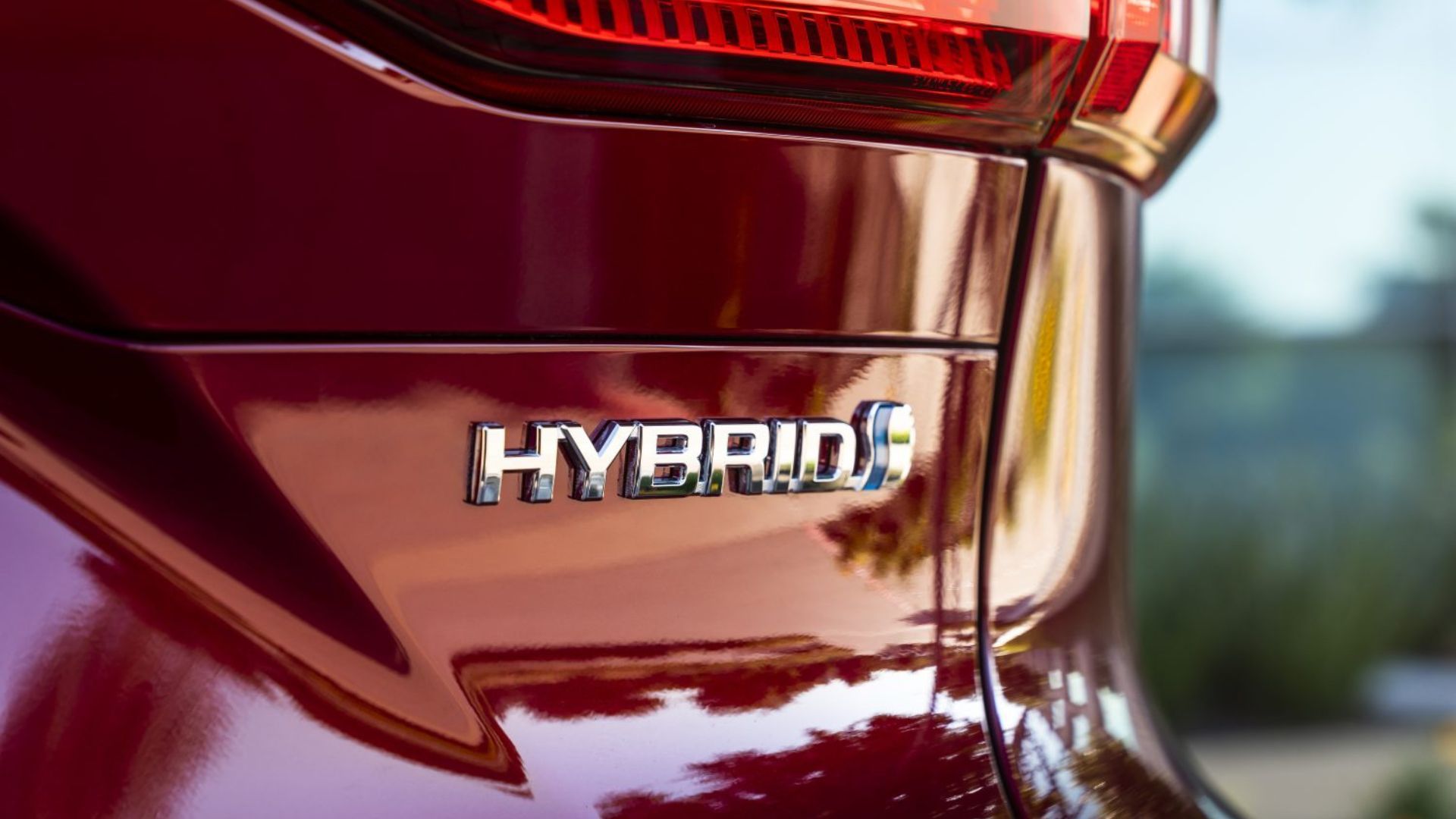 Close-up shot of the badging on the trunk lid of a red 2022 Toyota Venza LE.