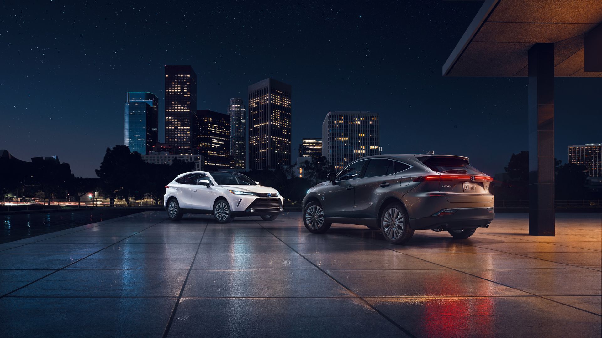 Static front 3/4 shot of a white 2024 Toyota Venza Limited and a rea3 3/4 shot of a gray model.