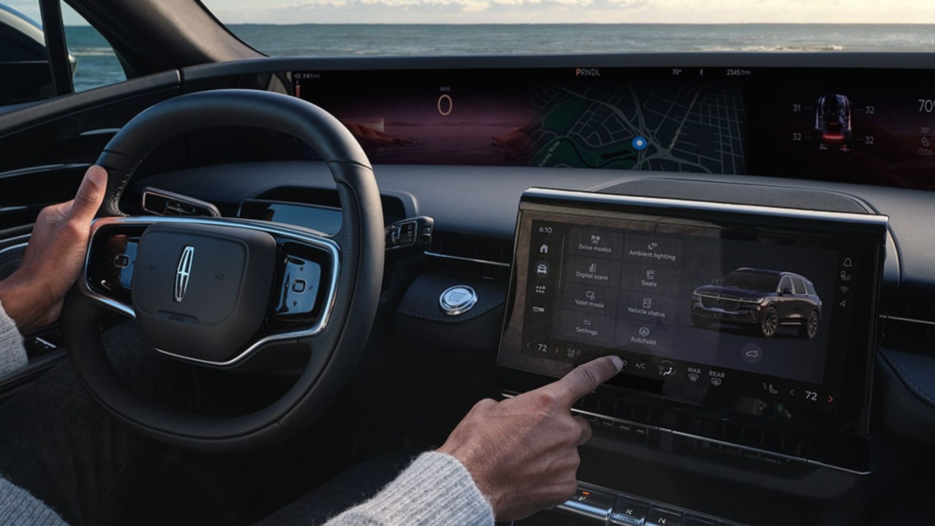 Shot of a male driver using the central touchscreen in a 2024 Lincoln Nautilus.