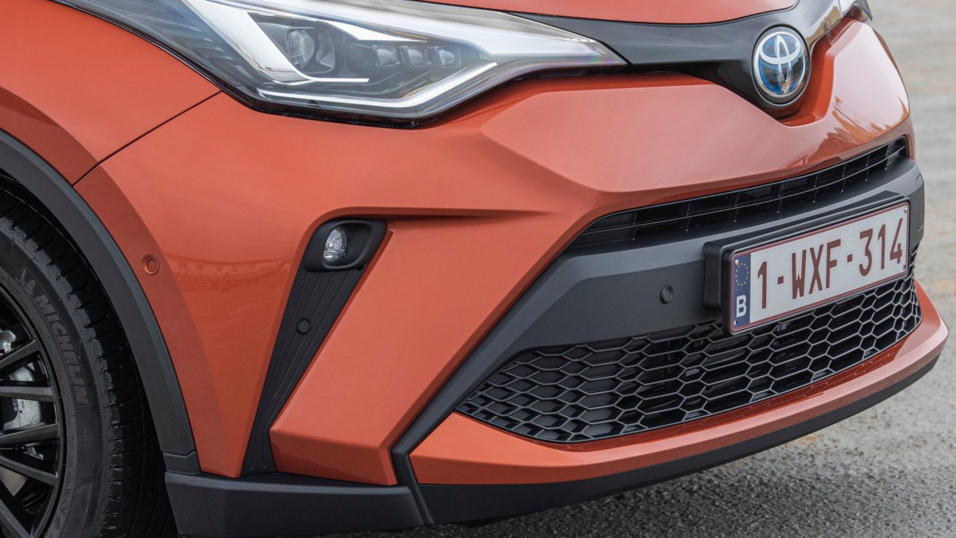 Close-up shot of the front end of an orange 2020 Toyota C-HR.