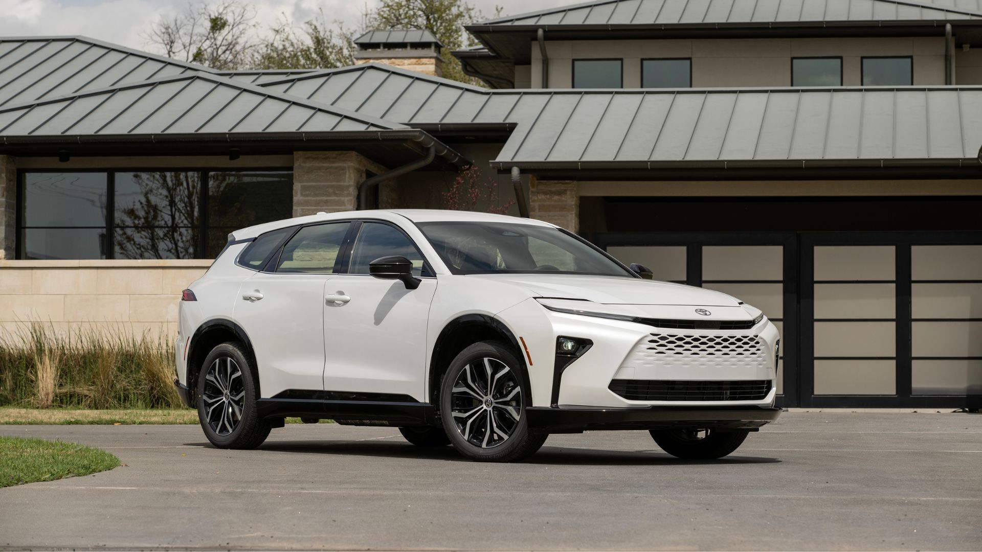 Frotn 3/4 shot of a white 2025 Toyota Crown Signia XLE parked outside of a building.